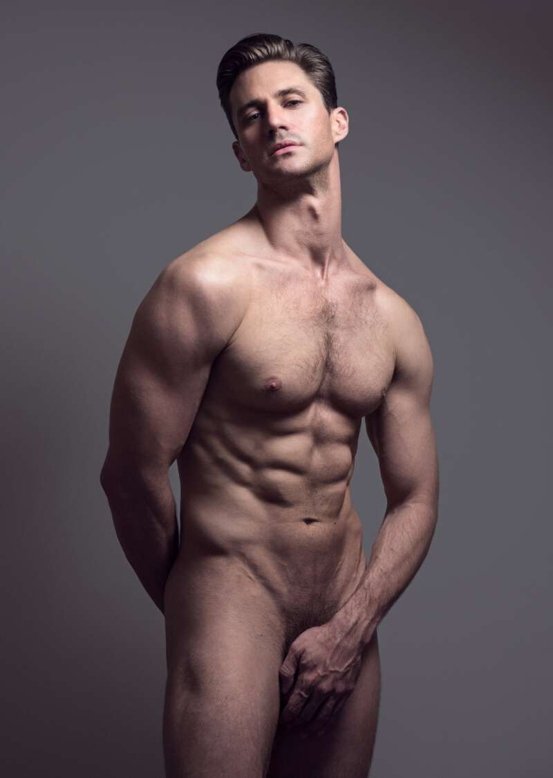 Nicholas Cunningham posing nude and hiding his manhood