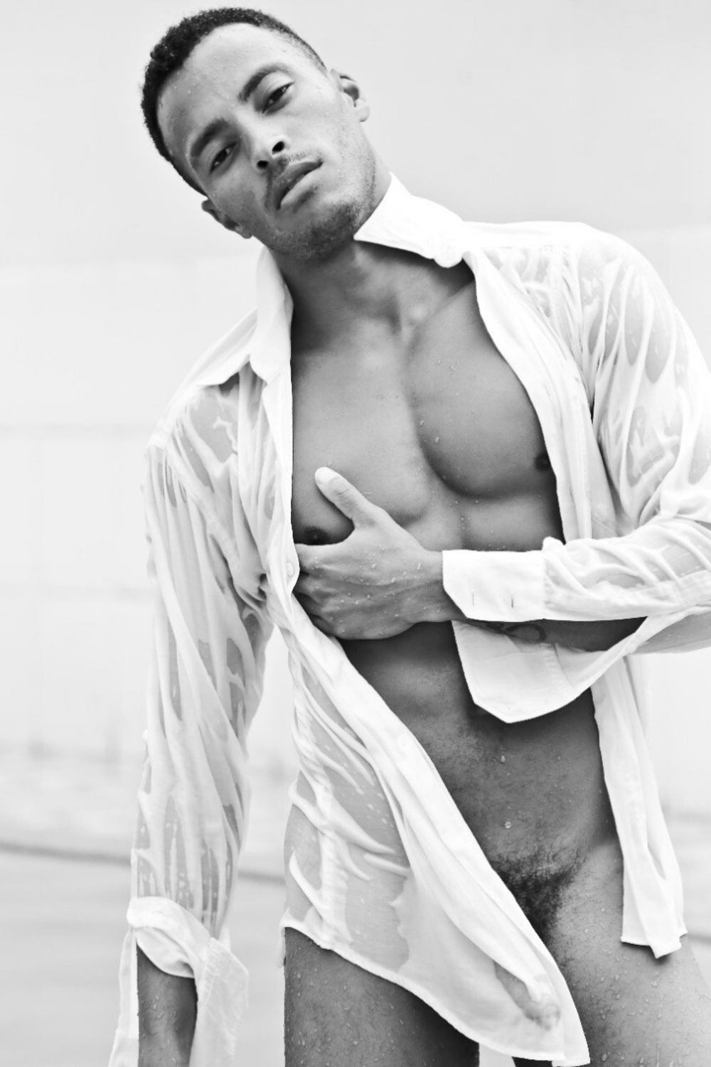 The shape of Deivid Barretto's big uncut cock is seen through the wet cotton of a white shirt